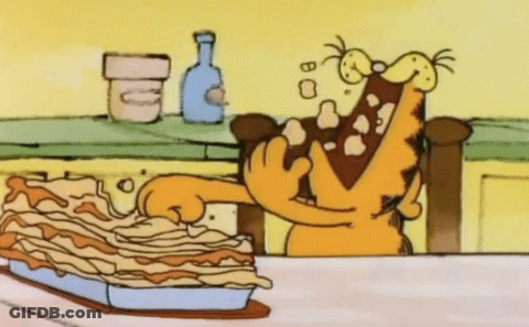 A Cartoon Of Garfield Eating A Pie With His Mouth Open GIF