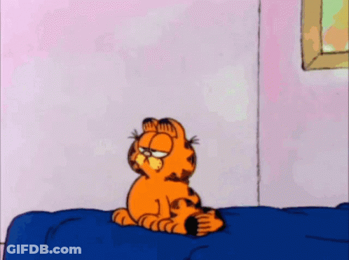 A Cartoon Of Garfield Standing On A Bed With His Eyes Closed GIF