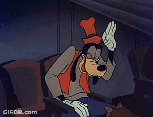 A Cartoon Of Goofy Sitting In A Chair With His Hand On His Head GIF