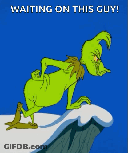A Cartoon Of Grinch Standing On A Cliff With The Words " Waiting On This Guy " Below Him GIF