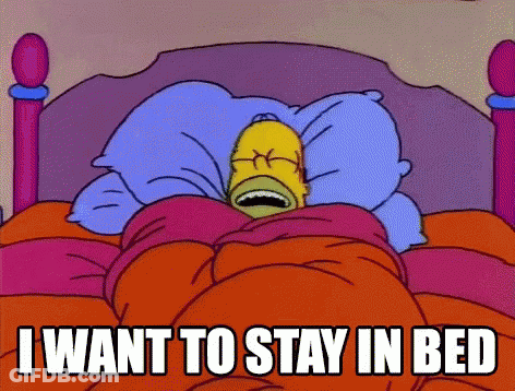 A Cartoon Of Homer Simpson Laying In Bed With The Words " I Want To Stay In Bed " Above Him GIF