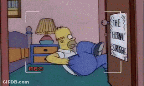 A Cartoon Of Homer Simpson Laying On A Bed With A Sign That Says The Eternal Struggle GIF