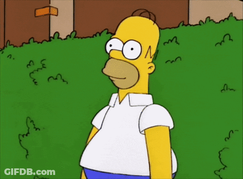 A Cartoon Of Homer Simpson Standing In Front Of A Green Bush GIF