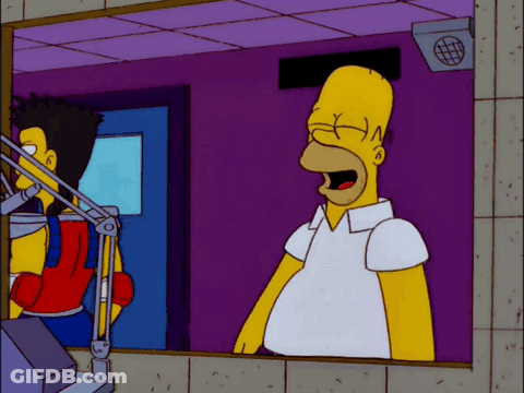 A Cartoon Of Homer Simpson Standing In Front Of A Microphone With His Mouth Open GIF