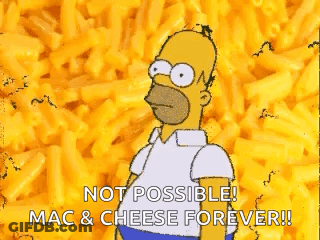 A Cartoon Of Homer Simpson Standing In Front Of A Pile Of Macaroni Cheese . GIF
