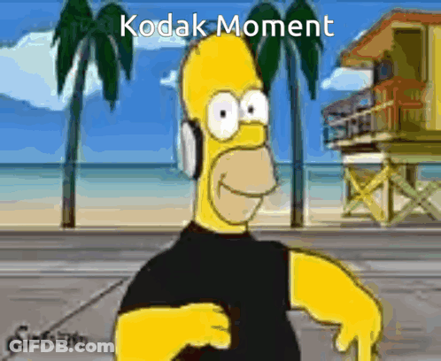 A Cartoon Of Homer Simpson Wearing Headphones With Kodak Moment Written In The Corner GIF