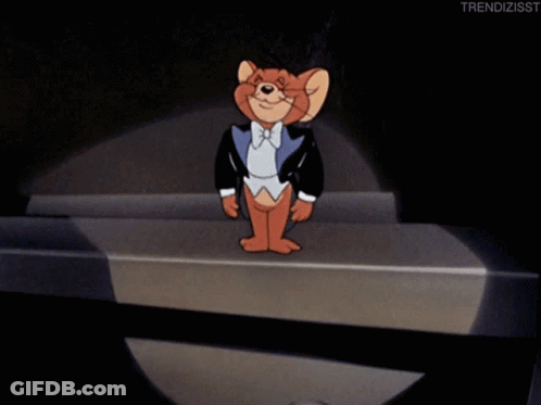 A Cartoon Of Jerry Wearing A Tuxedo And Bow Tie Is Standing On A Stage GIF