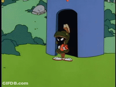 A Cartoon Of Marvin The Martian Standing In Front Of A Blue Tower GIF