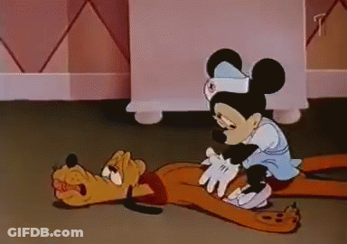 A Cartoon Of Mickey Mouse And Pluto Laying On The Ground GIF