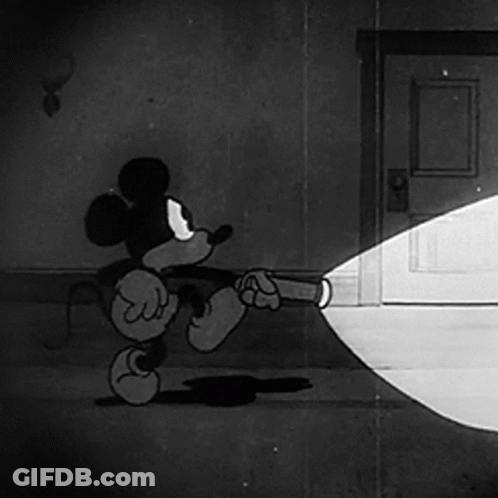 A Cartoon Of Mickey Mouse Holding A Flashlight GIF