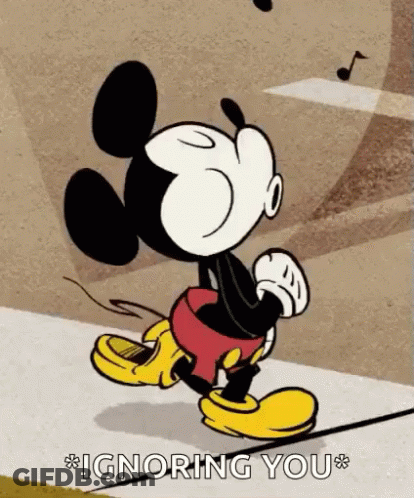 A Cartoon Of Mickey Mouse Walking Down A Sidewalk With The Words Ignoring You Above Him . GIF