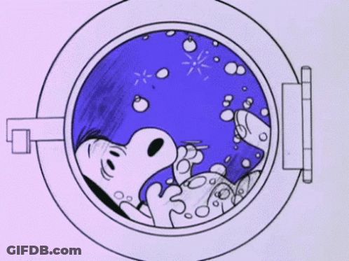 A Cartoon Of Snoopy Laying In A Washing Machine . GIF