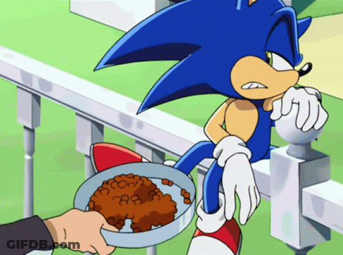 A Cartoon Of Sonic The Hedgehog With A Bowl Of Food In Front Of Him GIF