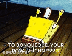 A Cartoon Of Spongebob Laying On A Wooden Floor With The Words `` To Bonqueque Your Royal Highness '' . GIF