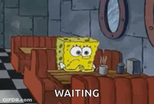 A Cartoon Of Spongebob Squarepants Sitting At A Table In A Diner . GIF