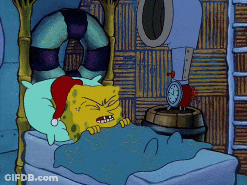 A Cartoon Of Spongebob Wearing A Santa Hat Laying In A Bed GIF