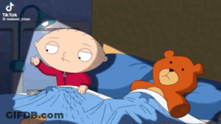 A Cartoon Of Stewie From Family Guy Laying In Bed Next To A Teddy Bear GIF