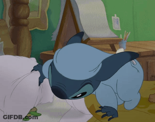 A Cartoon Of Stitch Laying On A Bed With A Frog Behind Him GIF