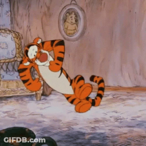 A Cartoon Of Tigger From Winnie The Pooh Laying On The Floor GIF