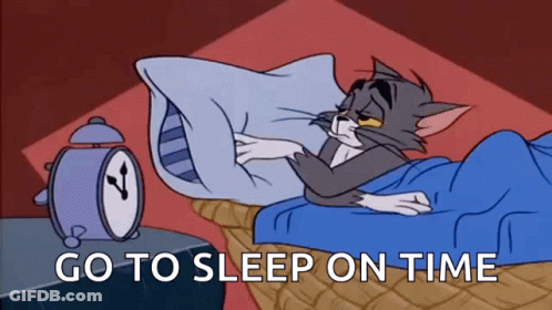A Cartoon Of Tom And Jerry Laying In Bed With An Alarm Clock Behind Them . GIF