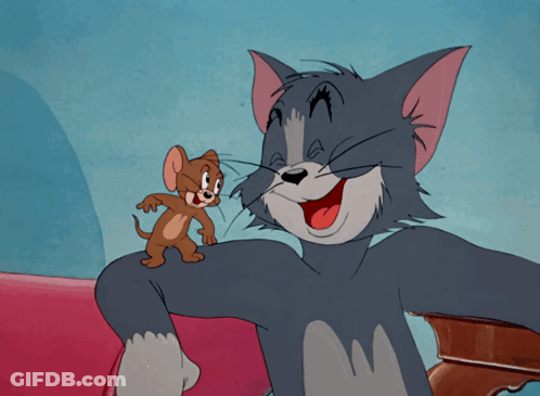 A Cartoon Of Tom And Jerry Sitting On A Red Couch GIF