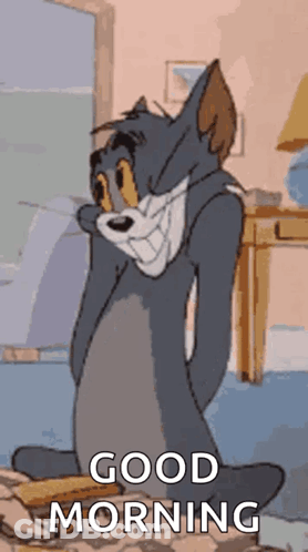 A Cartoon Of Tom From Tom And Jerry Is Sitting On A Bed With His Eyes Closed And Says Good Morning . GIF