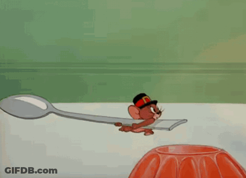 A Cartoon Of Tom Wearing A Feathered Headdress GIF