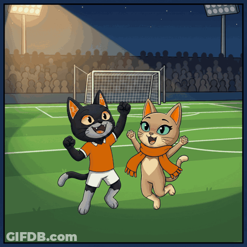 A Cartoon Of Two Cats On A Soccer Field With One Wearing An Orange Scarf GIF