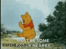A Cartoon Of Winnie The Pooh Dancing In A Field With The Words `` Must Be Some Honey Nearby '' . GIF