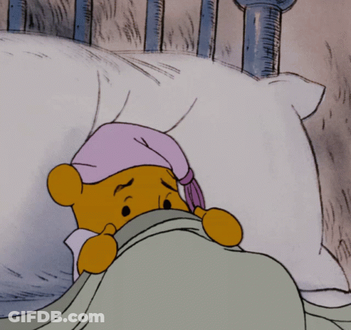 A Cartoon Of Winnie The Pooh Laying In Bed With A Purple Hat On GIF