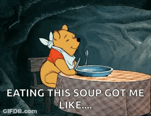 A Cartoon Of Winnie The Pooh Sitting At A Table With A Bowl Of Soup GIF
