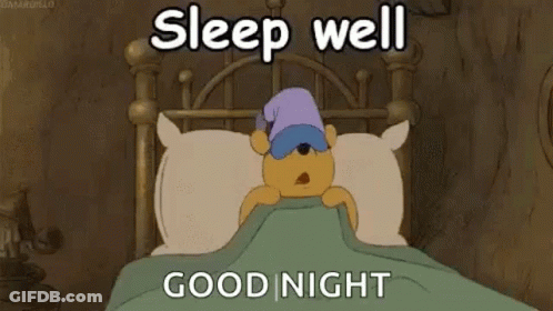 A Cartoon Of Winnie The Pooh Sleeping In A Bed With A Sleep Cap On . GIF