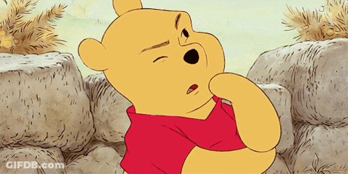 A Cartoon Of Winnie The Pooh With His Eyes Closed And A Red Shirt GIF