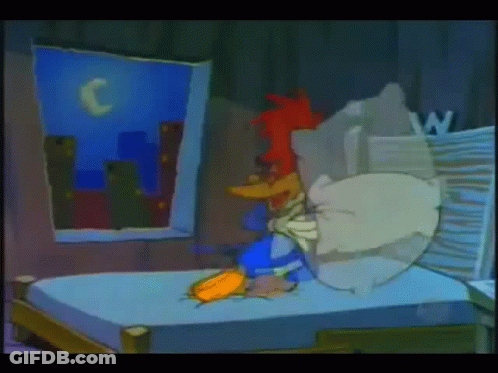 A Cartoon Of Woody Woodpecker Laying On A Bed In A Dark Room GIF