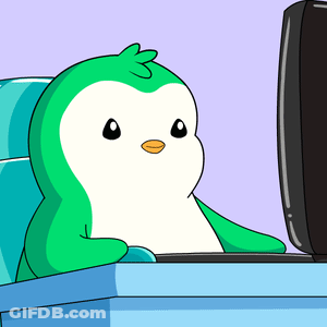 A Cartoon Penguin Is Sitting In Front Of A Computer Monitor GIF
