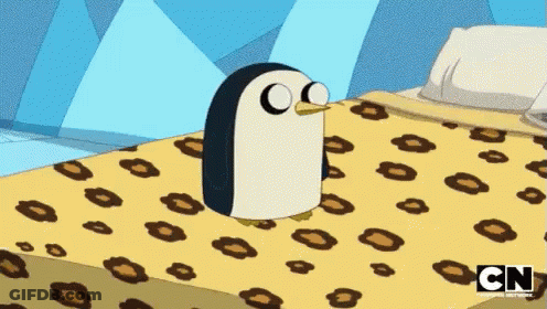 A Cartoon Penguin Is Sitting On A Bed With A Cn Logo On The Bottom GIF