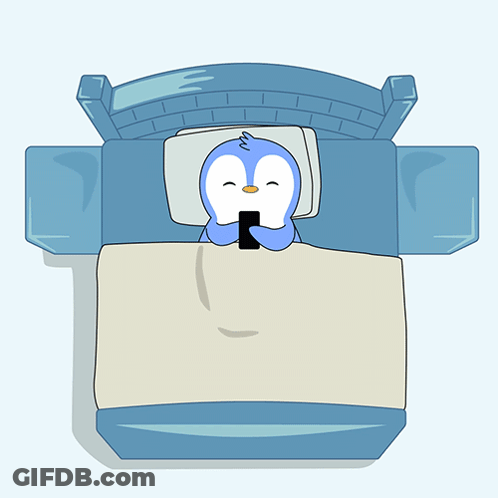 A Cartoon Penguin Is Sleeping In A Bed With A Cell Phone On The Blanket GIF