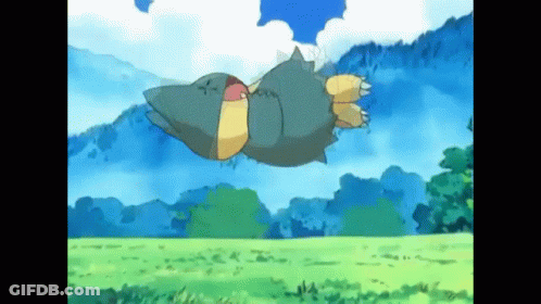 A Cartoon Pokemon Is Flying Through The Air Over A Grassy Field . GIF