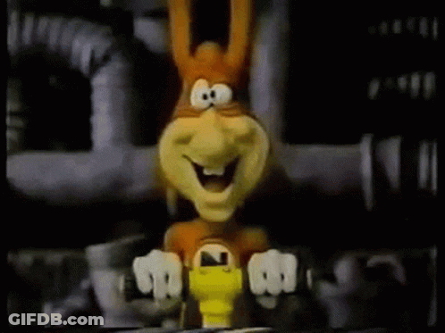 A Cartoon Rabbit Is Sitting On A Table With A Yellow Object In Front Of It . GIF