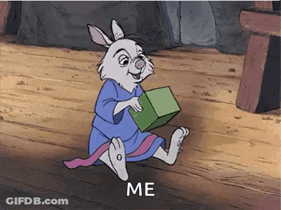 A Cartoon Rabbit Is Sitting On A Wooden Floor Holding A Green Box And Says `` Me '' . GIF