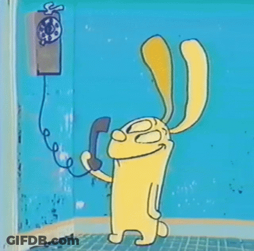 A Cartoon Rabbit Is Talking On A Pay Phone . GIF