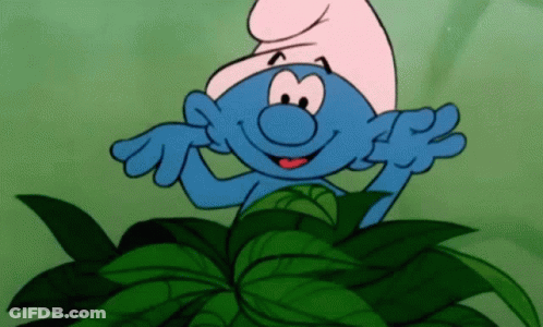A Cartoon Smurf Is Standing In A Pile Of Leaves . GIF