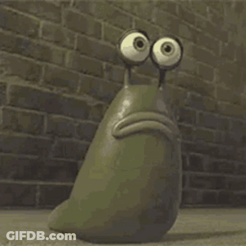 A Cartoon Snail With Big Eyes Is Sitting In Front Of A Brick Wall . GIF