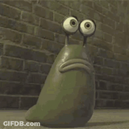 A Cartoon Snail With Big Eyes Is Sitting In Front Of A Brick Wall . GIF