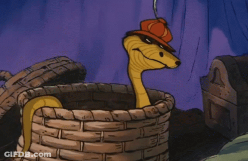 A Cartoon Snake Wearing A Red Hat Is Sitting In A Basket GIF