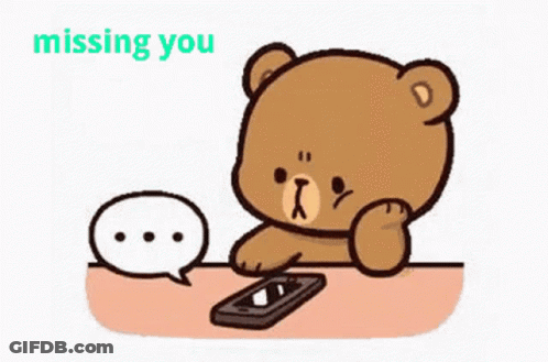 A Cartoon Teddy Bear Is Sitting At A Table With A Cell Phone And A Speech Bubble . GIF