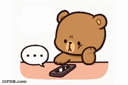 A Cartoon Teddy Bear Is Sitting At A Table With A Cell Phone . GIF