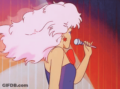 A Cartoon Woman Singing Into A Microphone With Pink Hair GIF