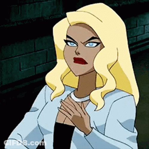 A Cartoon Woman With Blonde Hair And Blue Eyes Is Standing In Front Of A Brick Wall With Her Hands On Her Chest . GIF