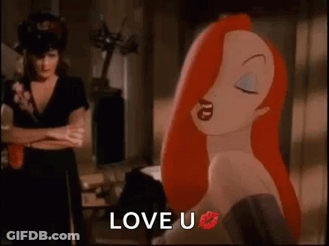 A Cartoon Woman With Red Hair And A Kiss On Her Lips Is Standing Next To A Woman With Her Arms Crossed . GIF